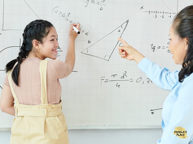 girl learning o level math from teacher