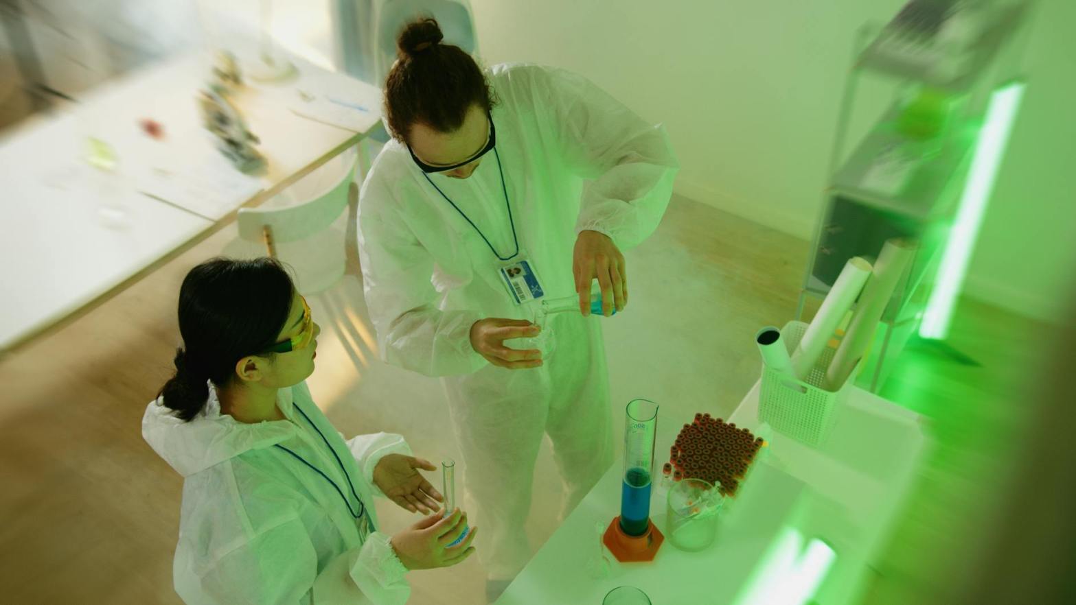 a man holding laboratory glasswares